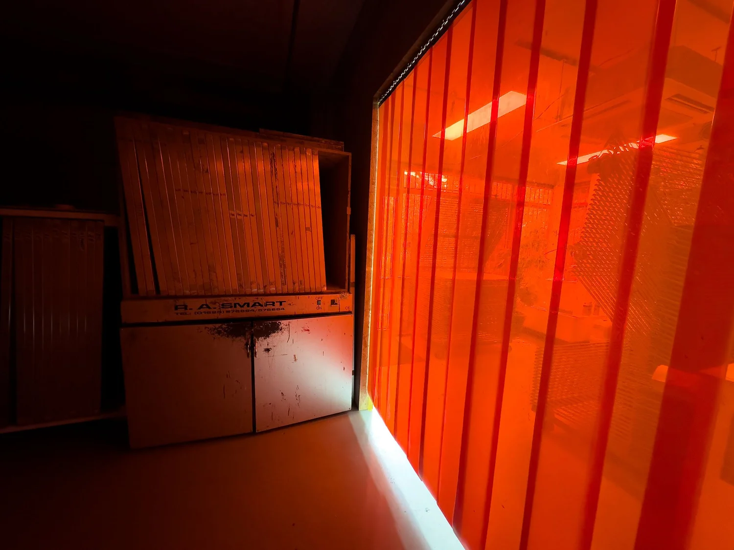 Silkscreen frames stored in the studio under red light