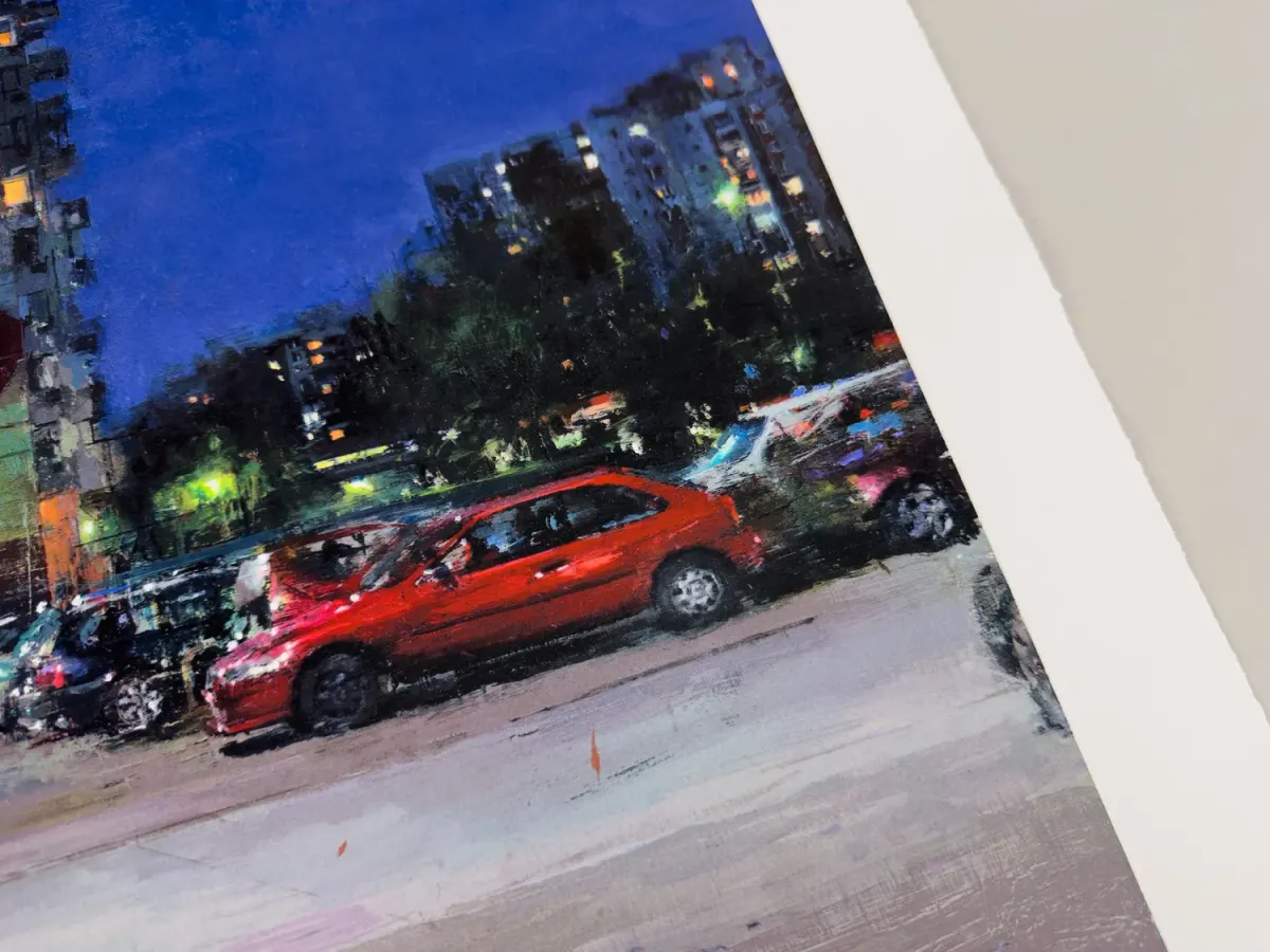 Detail of a city street print with a red car and blue evening sky